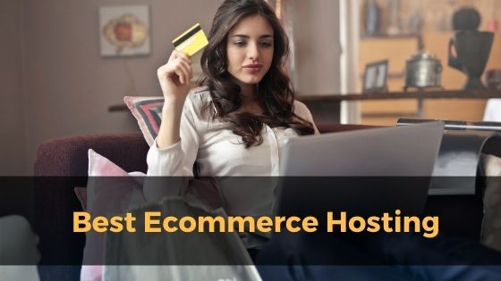 Women with credit card on hand in front of laptop
